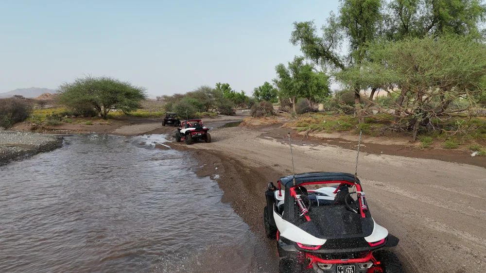 A FOX ATVs buggy crossing shallow water in Wadi Al Rak