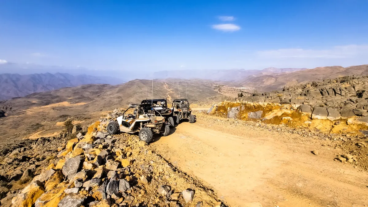 A convoy paused on an exposed mountain track during an earlier FOX ATVs journey