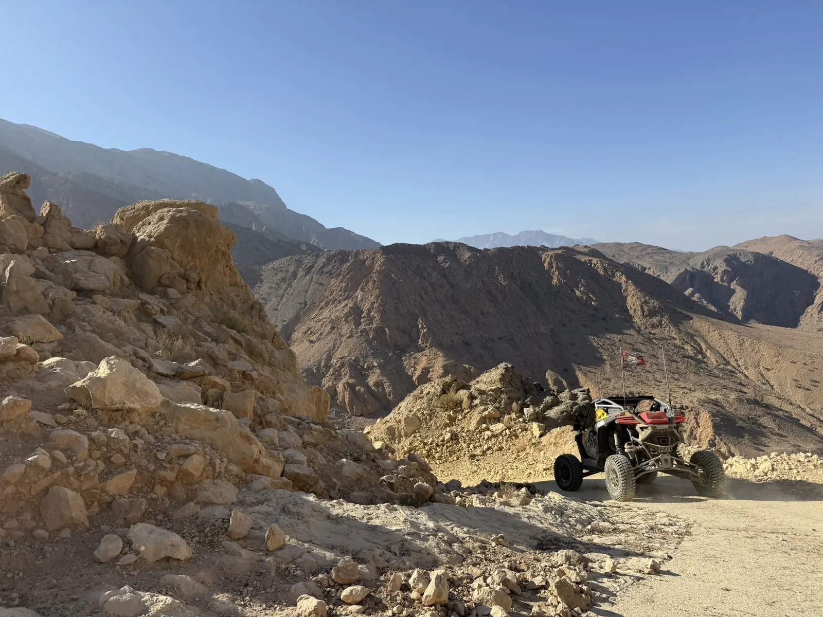 A UTV negotiating a rocky turn on an Omani mountain trail