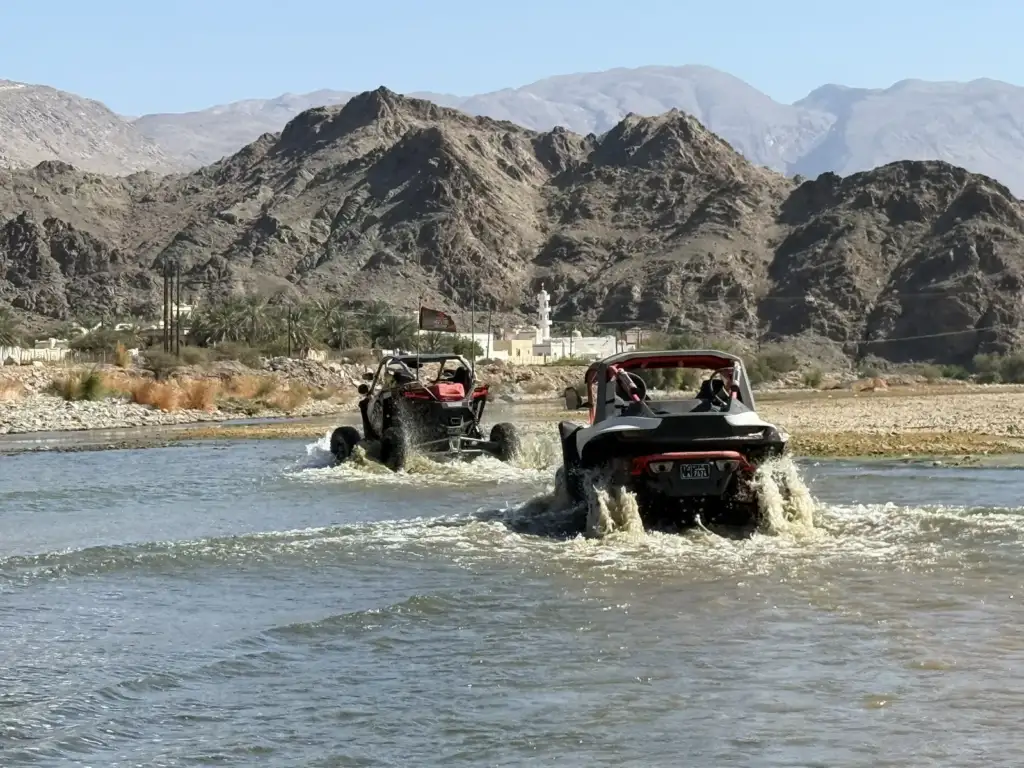 Two UTVs making a guided water crossing in Wadi Al Tayeen