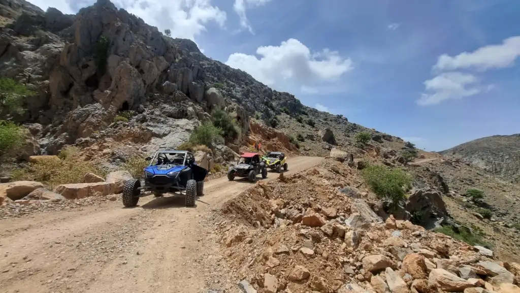 UTVs following a rocky Jabal Abyad mountain trail