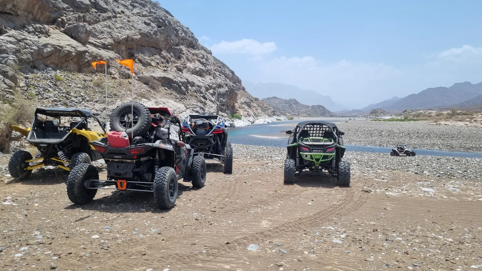 A FOX ATVS convoy beside a wadi crossing in Oman