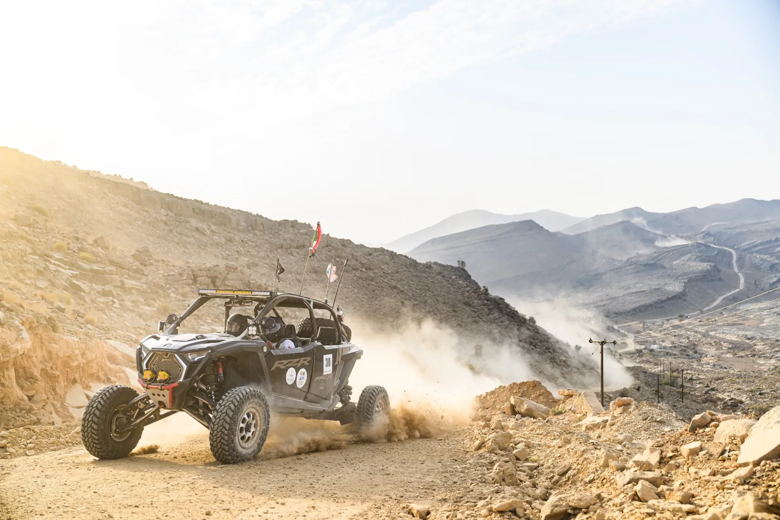 A FOX ATVs side-by-side climbing a mountain trail in Oman