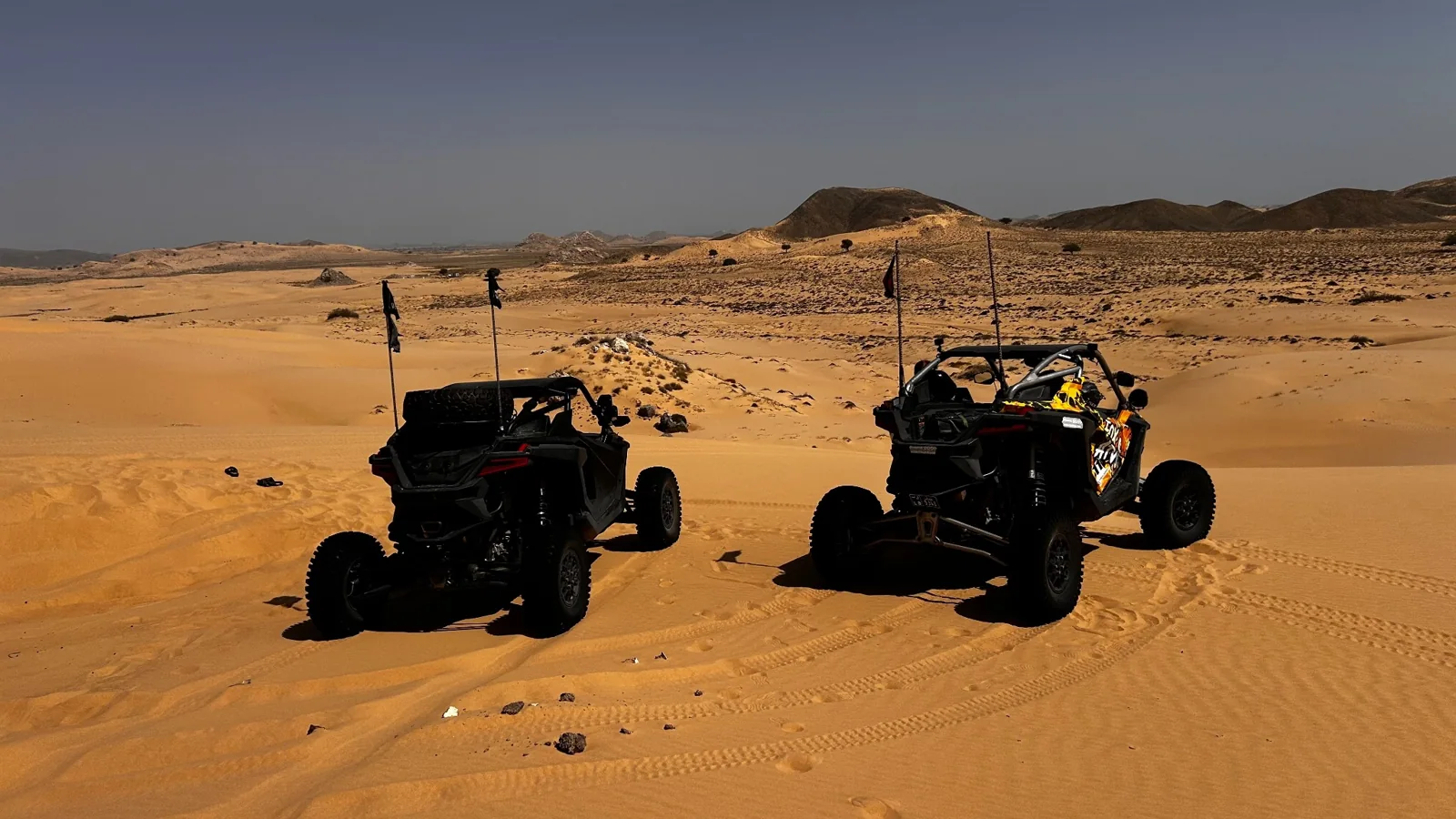 Two FOX ATVs buggies overlooking the dunes of Wahiba Sands