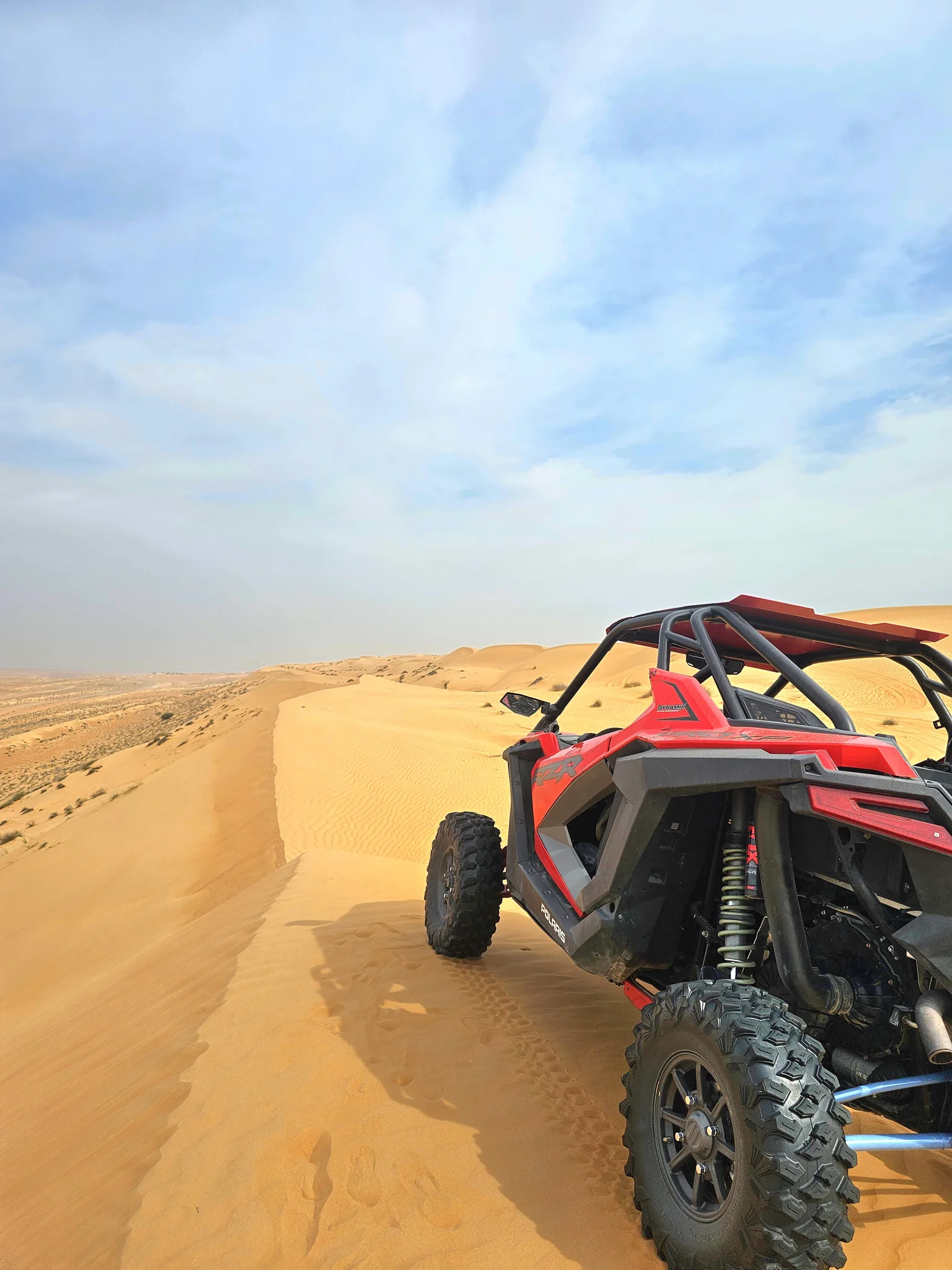Red dune buggy on a Sharqiya Sands trail