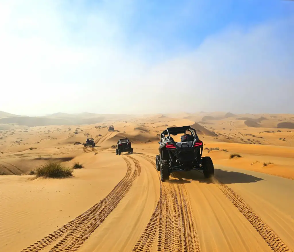 A guided FOXATVs convoy following a sandy desert route