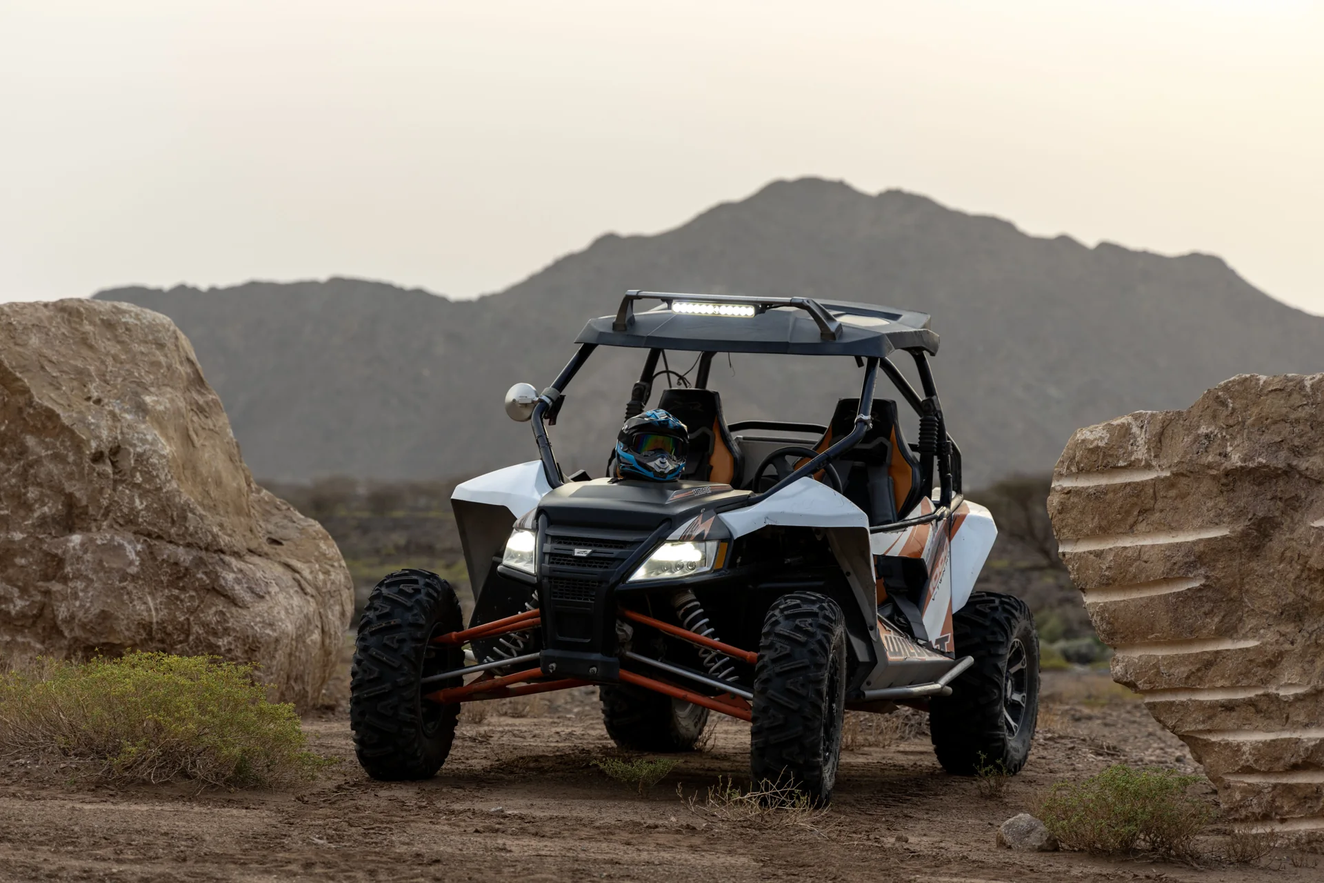 A FOXATVs side-by-side vehicle between rocks on a Wadi Al Rak trail