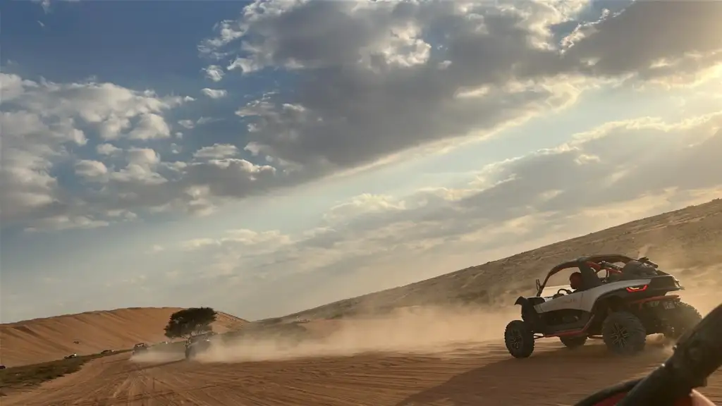 FOX ATVs buggy convoy driving across desert terrain in Oman