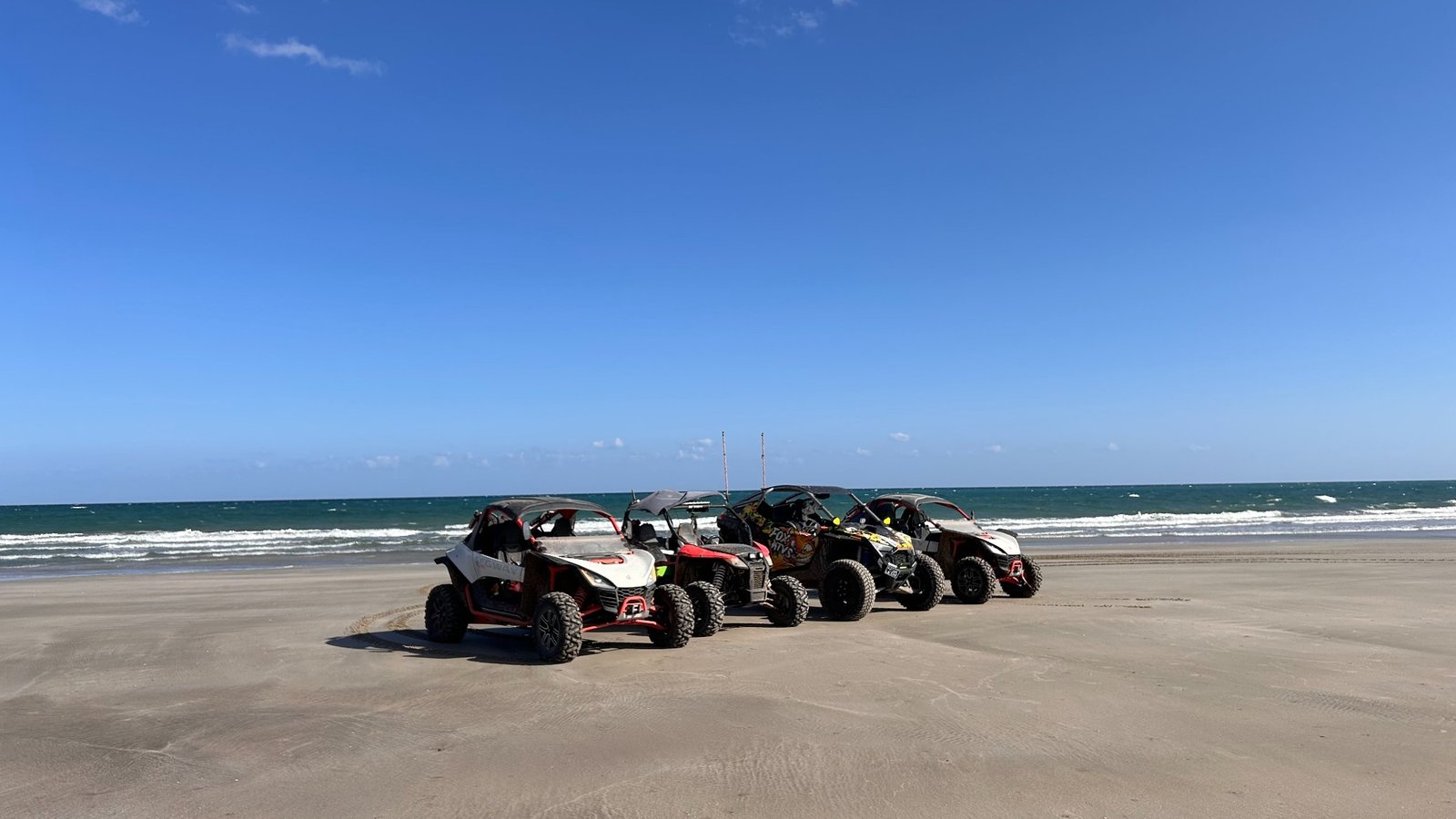 Four FOXATVs off-road buggies beside the Arabian Sea in Oman